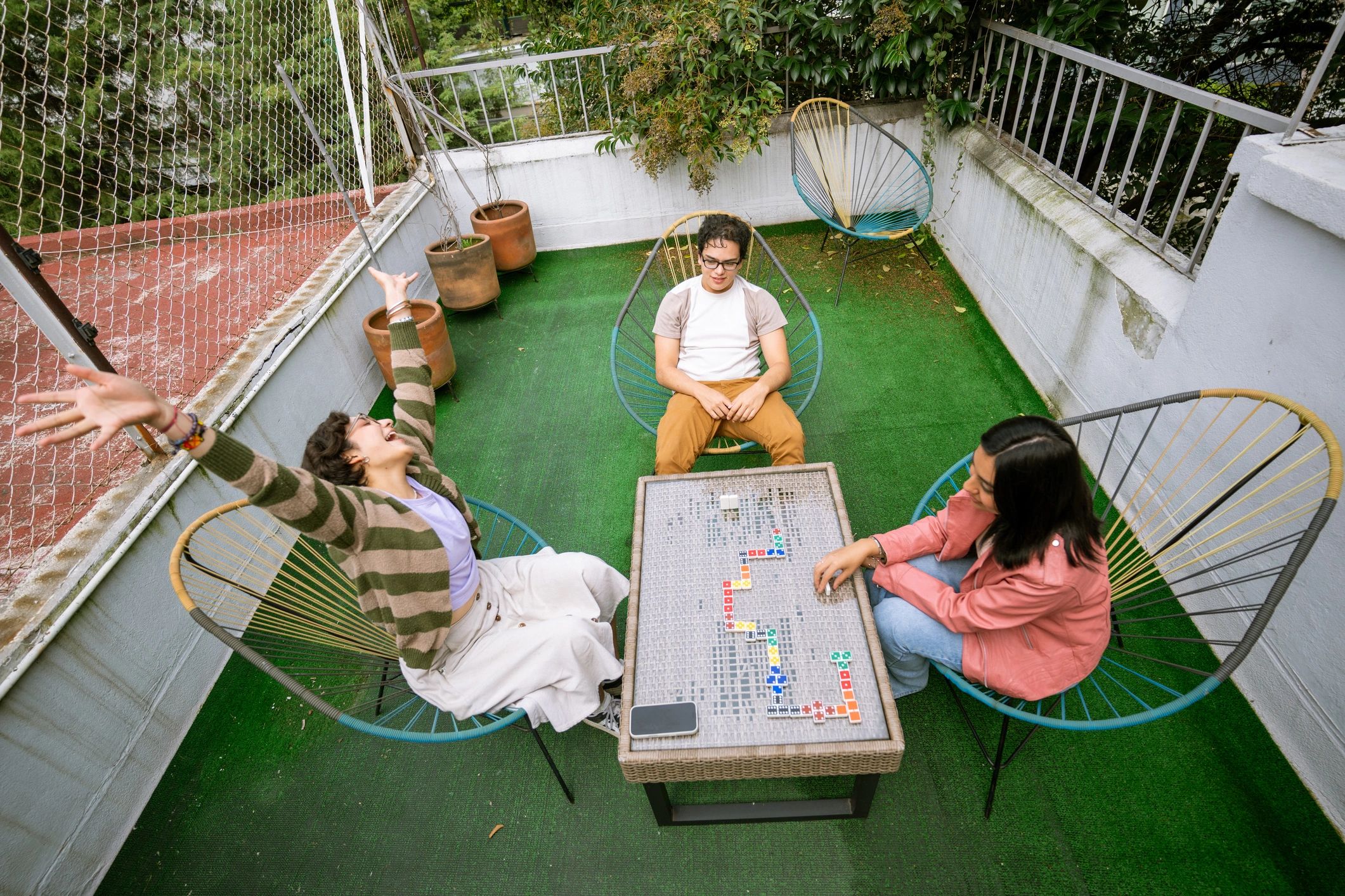 Friends gathered around a table enjoying a puzzle-like game together